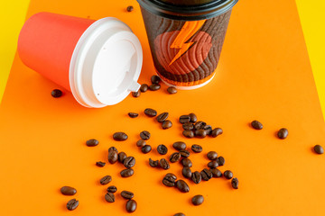 Wall Mural - a paper glass for hot drink with coffee beans on color background