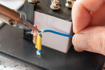 macro view of engineer solding process in his workshop