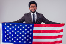 Business Male Wrapped Up American Flag In Studio White Background