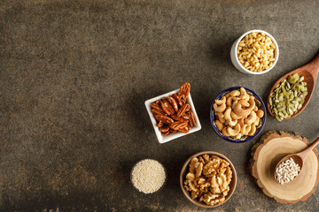 Wall Mural - Frame made of different types of nuts in bowls