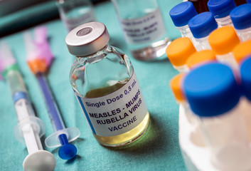 Different vials of triple viral vaccine of measles, rubella and mumps, known as MMR, conceptual image