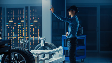 Poster - Automotive Engineer Working on Electric Car Chassis Platform, Using Augmented Reality Headset with Touching Gestures. In Innovation Laboratory Facility Concept Vehicle Frame with Wheels.