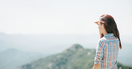 Poster - Woman looking into the distance in mountains.