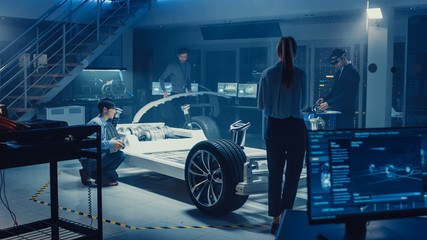 Fototapete - Automotive Design Engineers Work and Do Tests on Electric Car Chassis Prototype. In Innovation Laboratory Facility Concept Vehicle Frame Includes Wheels, Suspension, Engine and Battery.