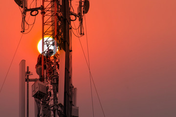  Engineer or Technician working on high tower,Risk work of high work, people are working with safety equipment on tower,Telecommunication