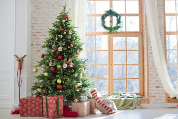 christmas tree and gift boxes near the window