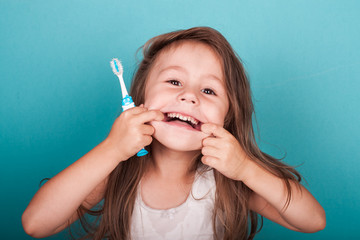 cute little girl brushing her teeth
