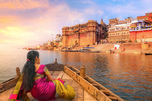 Ancient Varanasi City Architecture With Ganges River Bank. Indian Female Tourist Enjoy Boat Ride On The River Ganges At Sunset