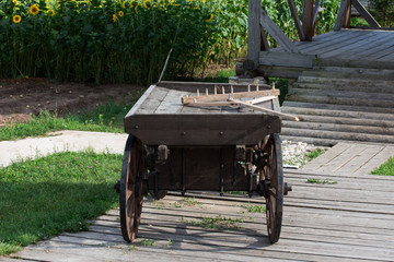 Vintage farm cart in countryside landscape. Agriculture and organic farming concept.