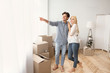 © Prostock-studio - Cheerful Man Showing Woman View From Window Of New House