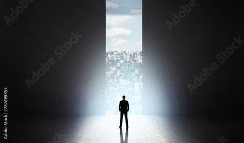 Man shadow on start new city building in front of big doors Tableau sur Toile