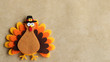 © sue - Felt turkey laying flat on a tan background with copy space
