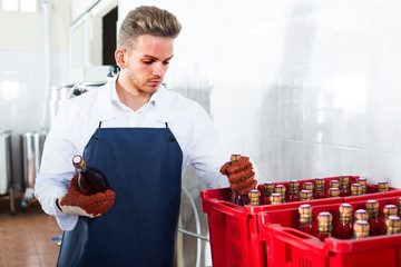 worker sorting wine bottles