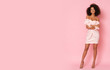 © forma82 - Sexy afro-american model in pink mini dress isolated on pink background.