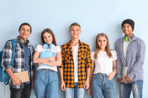 Fotografía Portrait of young students on color background