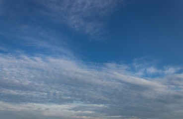 Blue sky background with tiny clouds