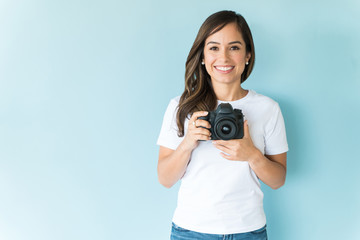 Wall Mural - Attractive Woman With Camera In Studio