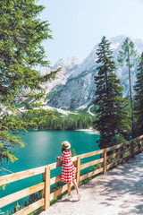 Poster - woman standing on the top looking at beautiful lake with mountains