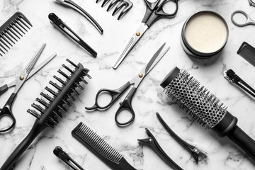 Canvas Print - Flat lay composition with scissors and other hairdresser's accessories on white marble background