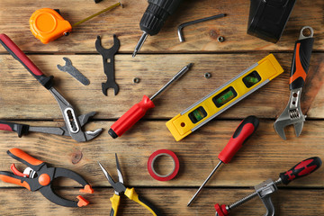 Set of repair tools on wooden background, flat lay