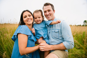 Portrait of a happy young family in the countryside