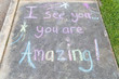 © Chad Robertson - the words 'I See You, You are Amazing' written with sidewalk chalk on gray concrete pavement background