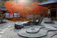 Autumn Scenery Of A Japanese Rock Garden ( Zen Garden, Dry Landscape, Or Karesansui ) In Morning Sunlight, At Honryutei In A Free Entry Public Park Famous For Its Fiery Maple Foliage In Kyoto, Japan