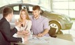 © BillionPhotos.com - Happy couple with car dealer in auto show or salon