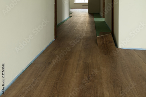 Quartz Vinyl Flooring Laying Of Dark Wood Color During Interior