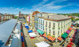 Fototapeta  - Aerial view of colorful houses at Findlay market in the re-gentrified, up and coming neighborhood Over the Rhine in Cincinnati Ohio USA with street vendors on a sunny summer morning