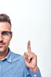 © Friends Stock - Look here Half face portrait of a smiling man with a stubble in eyewear gesturing and looking at camera
