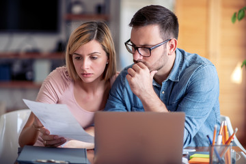 Poster - Worried young couple checking bills