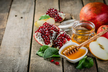 Rosh Hashana Jewish Holiday Concept - Apples, Honey, Pomegranate, Rustic Wood Background