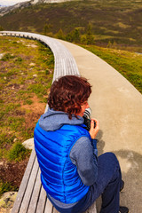 Canvas Print - Woman on Vedahaugane rest stop, Norway