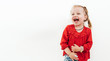 © Soloviova Liudmyla - Cheerful laughing little girl in red blouse . Studio Shooting on the white background.