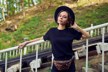 Girl in black clothes with a waist bag