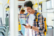 © Iryna - Young man is standing in a bus with headset on his head and listening to the music.