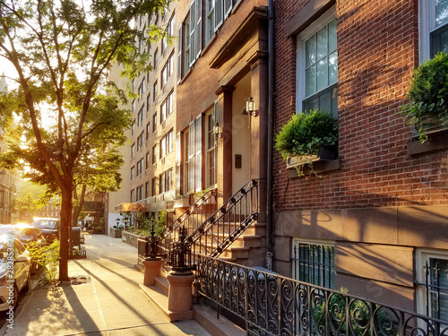 old-brownstone-buildings-along-a-quiet-neighborhood-street-in-greenwich-village-new-york-city