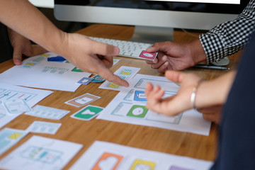 user experience UX designer designing web on smart phone layout. UI developer planning working on mobile application prototype