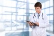 © BillionPhotos.com - Young woman doctor with stethoscope writting on black tablet