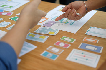 user experience UX designer designing web on smart phone layout. UI developer planning working on mobile application prototype
