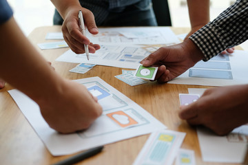 user experience UX designer designing web on smart phone layout. UI developer planning working on mobile application prototype