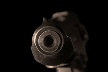 Gun Barrel Close Up On Black Background.Shooting Weapon