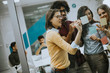 © BGStock72 - Young business people discussing in front of glass wall using post it notes and stickers
