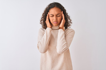 Wall Mural - Young brazilian woman wearing turtleneck sweater standing over isolated white background with hand on head for pain in head because stress. Suffering migraine.