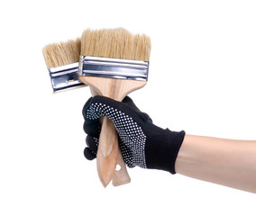 Poster - Hands in working gloves holding building paint brush on white background isolation