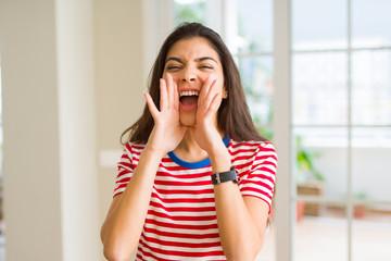 Sticker - Beautiful young woman shouting and screaming with hand on mouth very excited