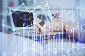 Financial graph displayed on woman's hand taking notes background. Concept of research. Double exposure