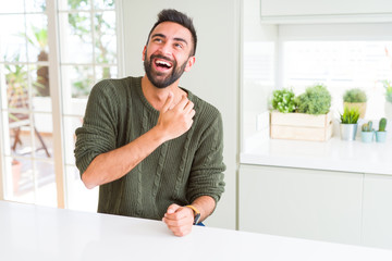 Handsome man smiling cheerful with a big smile on face showing teeth, positive and happy expression