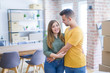 © Krakenimages.com - Young beautiful couple in love around cardboard boxes moving to new home, smiling very happy and cheerful for new apartment